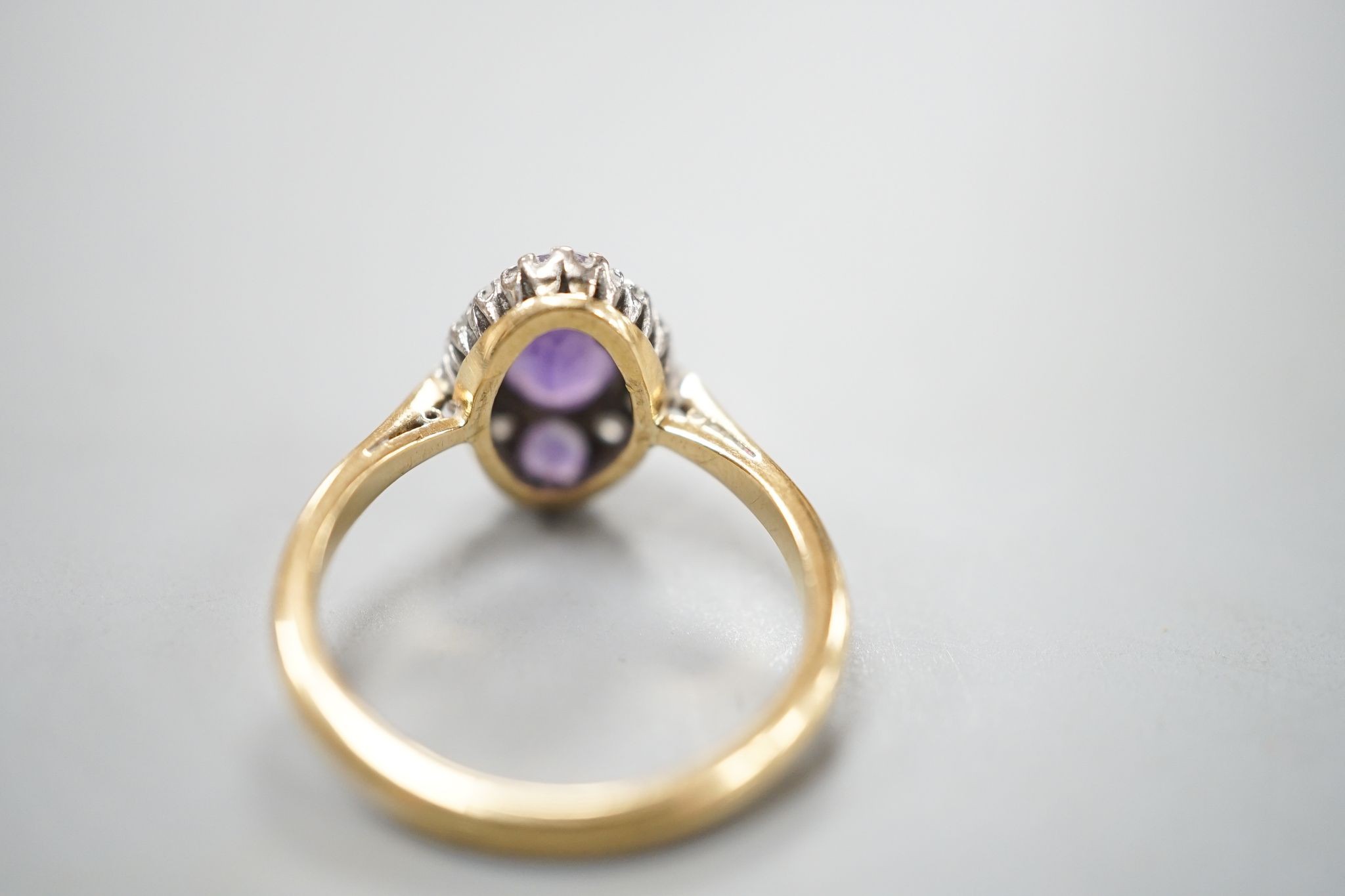An early 20th century 18ct & plat, amethyst and diamond set marquise cluster ring, size K, gross weight 3.2 grams.